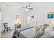 Serene bedroom with a comfortable bed and soft gray color palette, enhanced by natural light and ceiling fan at 512 Alderly Dr, Moncks Corner, SC 29461