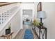 Bright entryway boasting hardwood floors, a staircase, and views into the kitchen and living room at 512 Alderly Dr, Moncks Corner, SC 29461