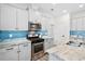Modern kitchen featuring stainless steel appliances, granite countertops, and blue backsplash at 512 Alderly Dr, Moncks Corner, SC 29461