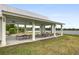 Spacious lakeside pavilion with multiple picnic tables and ceiling fans under a light-colored roof at 512 Alderly Dr, Moncks Corner, SC 29461