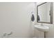 Stylish powder room with a modern pedestal sink, a decorative mirror, and sleek fixtures at 512 Alderly Dr, Moncks Corner, SC 29461