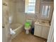Bathroom with a tub, toilet, sink, and floral wallpaper at 516 Arlington Dr # B5, Charleston, SC 29414