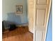 Small bedroom with hardwood floors and plain blue walls with white trim at 516 Arlington Dr # B5, Charleston, SC 29414