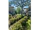 Exterior view of community buildings with mature trees, green grass, and flowerbeds at 516 Arlington Dr # B5, Charleston, SC 29414