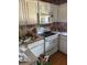 Small kitchen with white cabinets and white appliances with a white tile countertop at 516 Arlington Dr # B5, Charleston, SC 29414