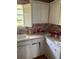 Small kitchen with white cabinets and white appliances with a white tile countertop at 516 Arlington Dr # B5, Charleston, SC 29414