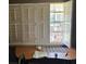 A window with white shutters and a work desk below at 516 Arlington Dr # B5, Charleston, SC 29414
