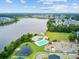 Aerial view of a lake community featuring pools, a playground and ample parking at 520 Crossland Dr, Moncks Corner, SC 29461