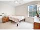 This cozy bedroom offers a light, airy feel with a ceiling fan and view from a large window at 520 Crossland Dr, Moncks Corner, SC 29461