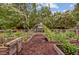 Scenic view of the community garden with raised beds, lush greenery, and a peaceful atmosphere at 520 Crossland Dr, Moncks Corner, SC 29461