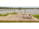 Wooden dock on a calm lake with a picnic table ready for lakeside dining and relaxation at 520 Crossland Dr, Moncks Corner, SC 29461