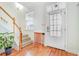 Bright entryway with hardwood floors, staircase, and white front door with glass panels at 520 Crossland Dr, Moncks Corner, SC 29461