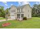 Charming two-story home featuring a cozy front porch, well-maintained lawn, and attached two-car garage at 520 Crossland Dr, Moncks Corner, SC 29461