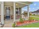 Inviting front porch with decorative railing, beautiful flower boxes, and a stone-accented facade at 520 Crossland Dr, Moncks Corner, SC 29461
