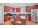 Modern kitchen boasting granite countertops, stainless steel appliances, and rich wood cabinetry at 520 Crossland Dr, Moncks Corner, SC 29461