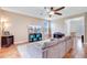 Comfortable living room featuring hardwood floors, a ceiling fan, and plenty of natural light at 520 Crossland Dr, Moncks Corner, SC 29461