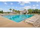 A pristine pool area with lounge chairs, palm trees, and a clubhouse, perfect for relaxation at 520 Crossland Dr, Moncks Corner, SC 29461