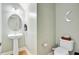 A modern powder room boasts a pedestal sink, stylish fixtures, and elegant finishes at 520 Crossland Dr, Moncks Corner, SC 29461