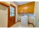 Laundry room features a washer, dryer, cabinets and exterior access door at 5322 Chantilly Ln, North Charleston, SC 29418