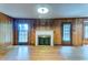 Cozy living room features wood paneled walls, hardwood floors, and a fireplace with a white mantel at 5322 Chantilly Ln, North Charleston, SC 29418