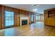 Charming living room with hardwood floors, wood paneling, a fireplace, and natural light at 5322 Chantilly Ln, North Charleston, SC 29418