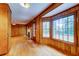 Spacious living room features hardwood floors, wood paneling and a large window for natural light at 5322 Chantilly Ln, North Charleston, SC 29418