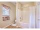 Bright bathroom features a shower-tub combo with white tile and a decorative window at 5347 Sundial Ct, North Charleston, SC 29418