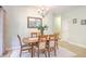 Formal dining room features wood table and chairs with decorative chandelier and mirror at 5347 Sundial Ct, North Charleston, SC 29418