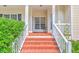 Inviting front entrance with brick steps, white railings, and a view into the well-lit home at 5347 Sundial Ct, North Charleston, SC 29418