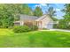 Inviting one-story home with a manicured lawn, covered porch, and attached garage at 5347 Sundial Ct, North Charleston, SC 29418