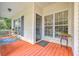 Cozy covered porch with seating, plants, and views of the surrounding greenery and neighborhood at 5347 Sundial Ct, North Charleston, SC 29418