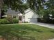 Charming home featuring a well-manicured lawn and a welcoming front porch, offering great curb appeal at 5347 Sundial Ct, North Charleston, SC 29418