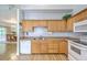 Fully equipped kitchen with light wood cabinets, stainless sink, and white appliances at 5347 Sundial Ct, North Charleston, SC 29418