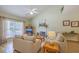 Comfortable living room featuring vaulted ceilings, a fireplace, and large windows for natural light at 5347 Sundial Ct, North Charleston, SC 29418