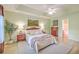 Inviting main bedroom featuring tray ceiling, light green paint, and neutral-colored furniture at 5347 Sundial Ct, North Charleston, SC 29418