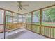 Screened porch features a swing, offering a serene view of the landscaped backyard at 5347 Sundial Ct, North Charleston, SC 29418