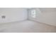 Empty room features neutral carpet and paint and one window for natural light at 5347 Sundial Ct, North Charleston, SC 29418