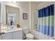 Bathroom with a single vanity, toilet, and a shower/tub combination with a blue and white curtain at 576 Polaris Way, Summerville, SC 29486
