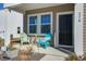 Inviting front porch with colorful Adirondack chairs, stylish pillows, and a welcoming entryway at 576 Polaris Way, Summerville, SC 29486