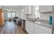 Bright kitchen open to living area features stainless steel appliances and granite countertops at 576 Polaris Way, Summerville, SC 29486