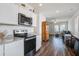 Open concept kitchen with stainless steel appliances, granite countertops, and wood-look flooring at 576 Polaris Way, Summerville, SC 29486