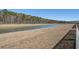 View of the retention pond, with a grass bank and treeline in the distance at 576 Polaris Way, Summerville, SC 29486