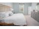 Serene main bedroom with a wicker bed frame and plush bedding with ample natural light at 602 Quiet Valley Rd, Summerville, SC 29486