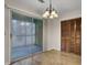 Dining room boasts a chandelier light and sliding door access to screened-in porch at 6241 Rolling Fork Rd # C, North Charleston, SC 29406