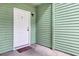Cozy entryway featuring a white door and green siding at 6241 Rolling Fork Rd # C, North Charleston, SC 29406
