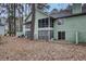 Back exterior featuring screened-in porch and private yard at 6241 Rolling Fork Rd # C, North Charleston, SC 29406