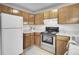 Efficient kitchen with wood cabinets and white appliances at 6241 Rolling Fork Rd # C, North Charleston, SC 29406