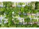Aerial view showcasing the neighborhood homes surrounded by mature trees and greenery at 886 Friendly Cir, Charleston, SC 29414