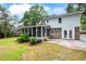 Backyard features a screened porch, brick accents, and a well-maintained lawn, offering a perfect outdoor retreat at 886 Friendly Cir, Charleston, SC 29414