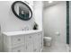 Modern bathroom with white vanity, elegant mirror, and tiled shower at 886 Friendly Cir, Charleston, SC 29414
